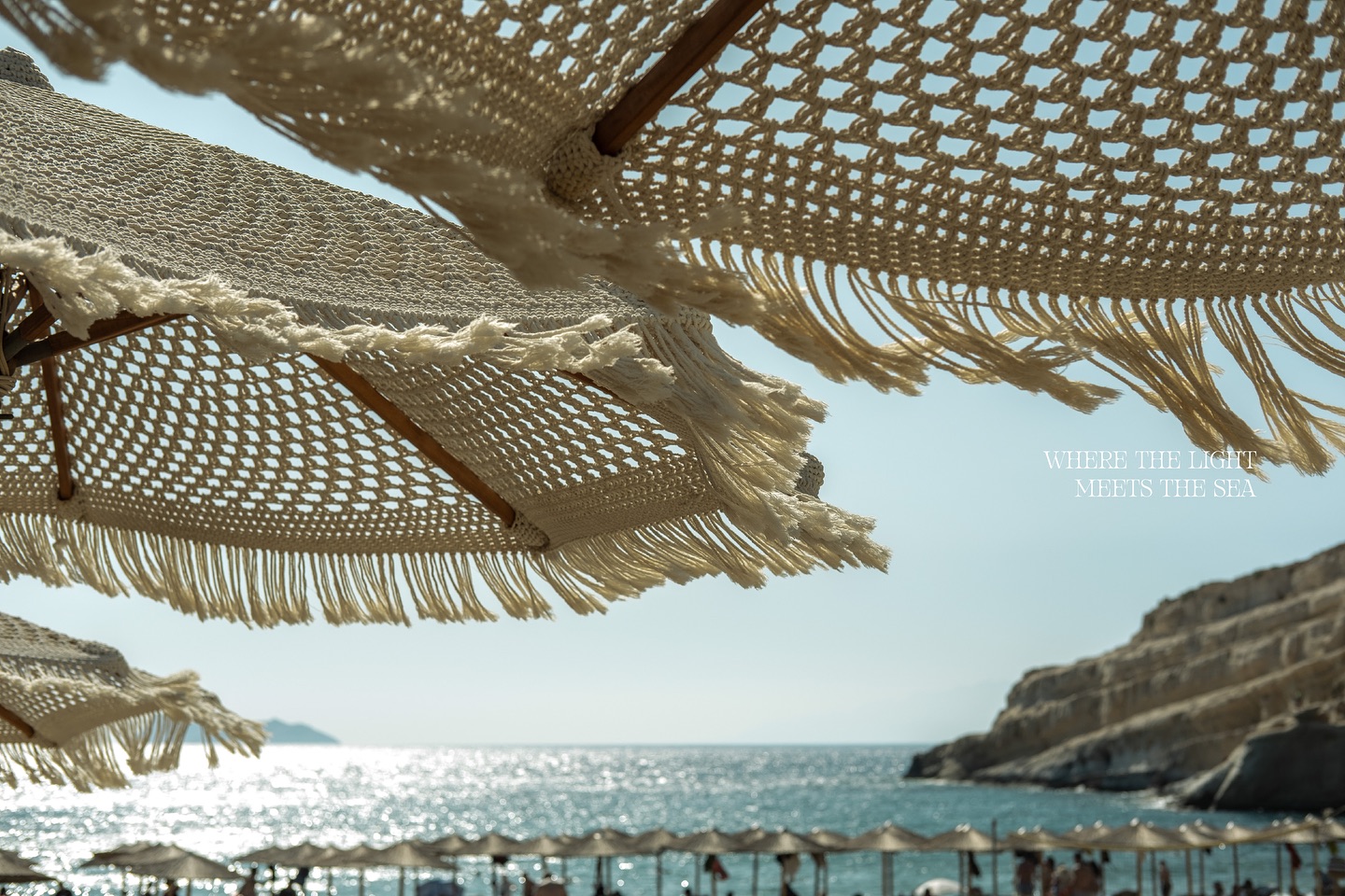 Afternoon sea view through woven umbrellas