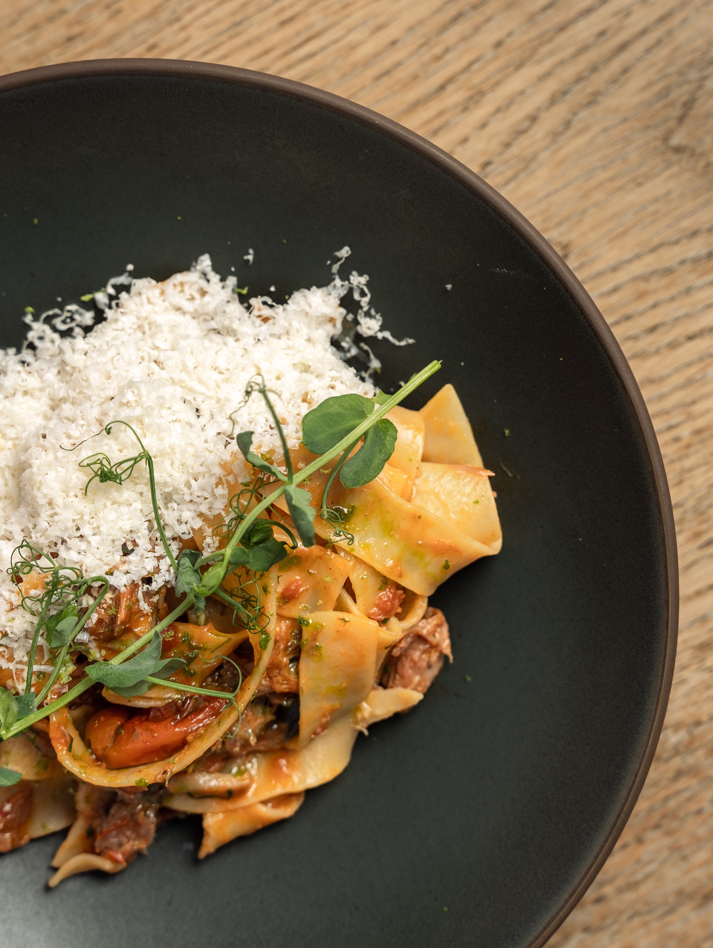 Seafood pasta served on a black plate
