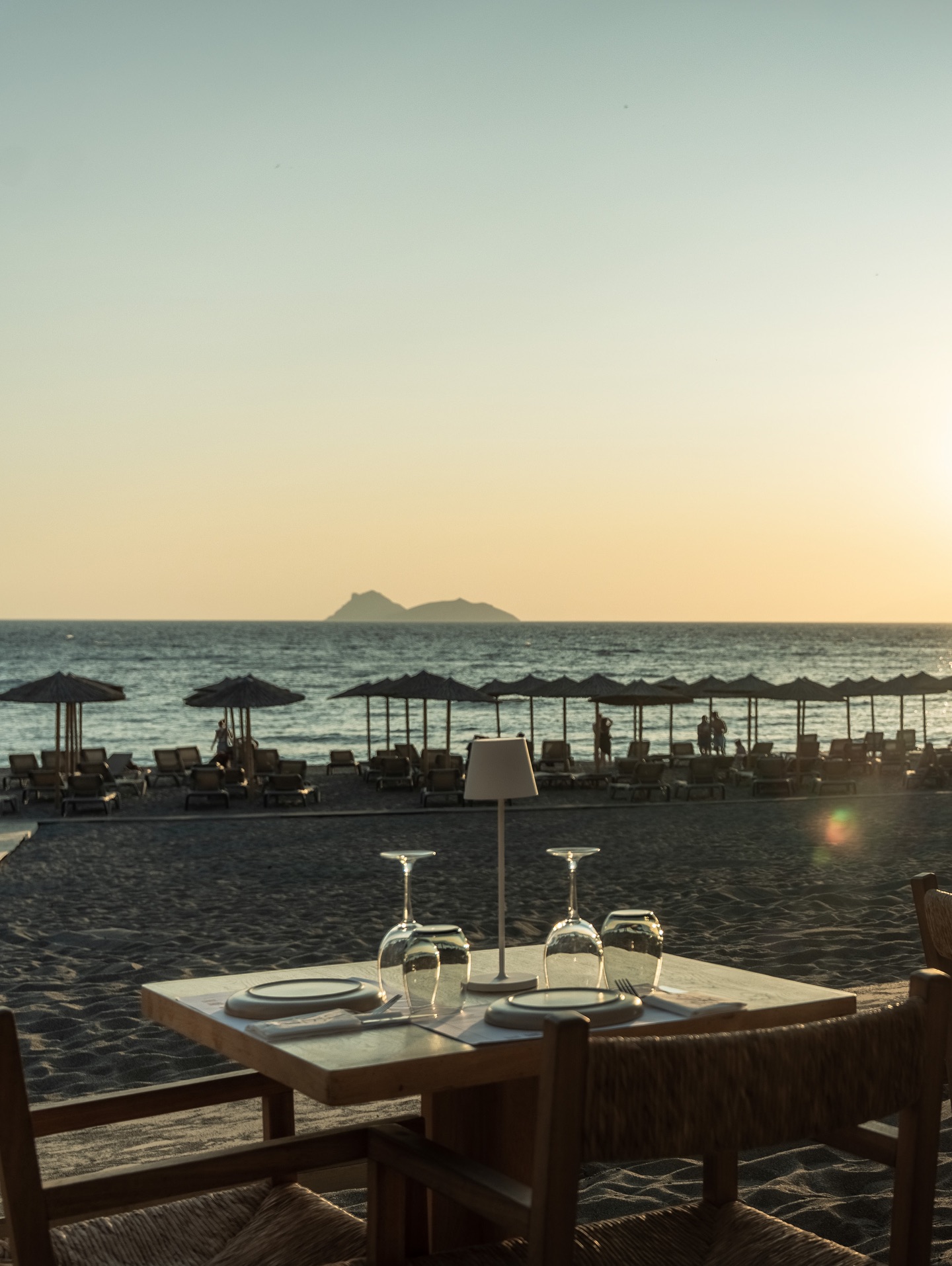 Table for two on the sand facing the sunset over the Libyan Sea